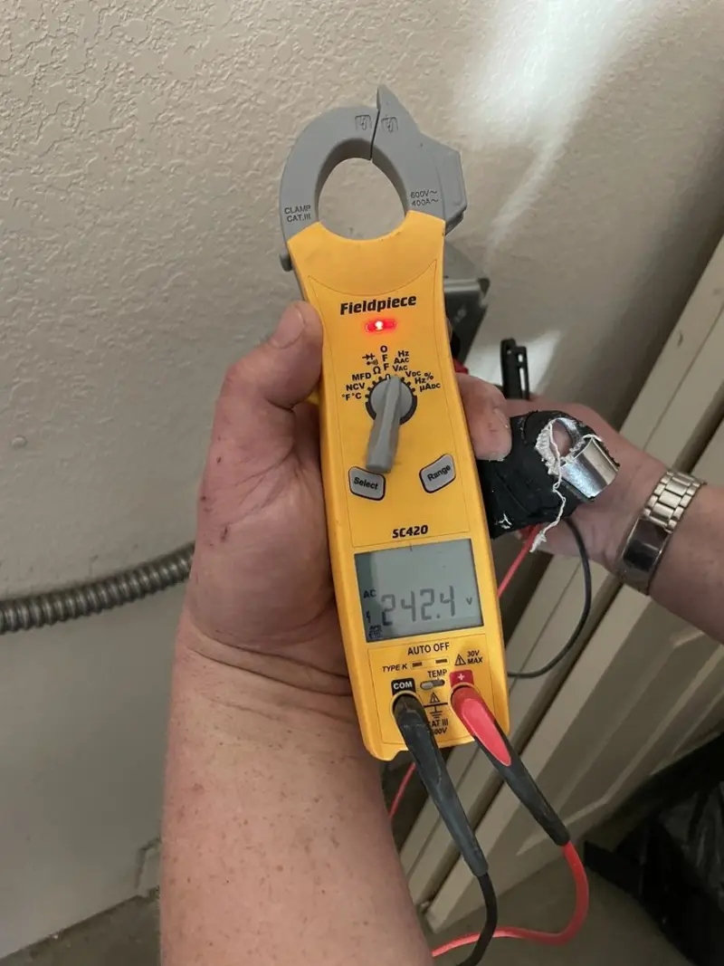 Voltage testing with clamp meter during Outlet Installation in Plymouth